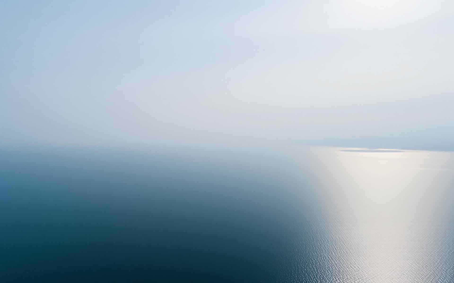 Open water meeting a soft horizon at dawn